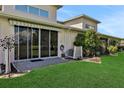 Spacious backyard with a patio and lush green grass at 35 Enclave Dr, Winter Haven, FL 33884