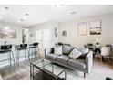 Living room with gray sofa, coffee table, and dining area at 1532 Still Dr, Clermont, FL 34714