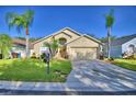 Charming house exterior with a two-car garage at 1357 Rebecca Dr, Haines City, FL 33844