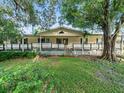 Ranch home with large front porch and mature landscaping at 126 Bermuda Ct, Winter Haven, FL 33880