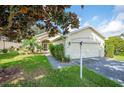 Single story home with two car garage and landscaped yard at 4189 Cannes Ave, Lake Wales, FL 33859
