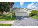 Single story home with two car garage and landscaped yard at 4189 Cannes Ave, Lake Wales, FL 33859