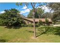 Ranch-style brick home with mature landscaping at 109 Odin Dr, Winter Haven, FL 33884