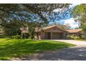 Brick home with a two-car garage and lush lawn at 109 Odin Dr, Winter Haven, FL 33884