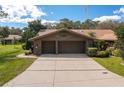 Front view of two-car garage and brick home at 109 Odin Dr, Winter Haven, FL 33884