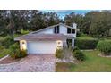 Mid-century modern home with white exterior and landscaped yard at 111 Arrowhead Ln, Haines City, FL 33844