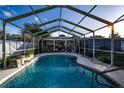 Swimming pool with screened enclosure and waterfall feature at 672 Wakulla Dr, Winter Haven, FL 33884