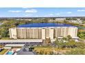 An aerial view showcasing a condo building near a lake, offering ample parking at 700 Mirror Nw Ter # 508, Winter Haven, FL 33881