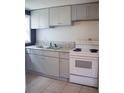 Simple kitchen with white appliances and gray cabinets at 3834 Avenue O Nw, Winter Haven, FL 33881