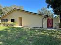 Condo exterior with red fence and landscaping at 1039 Medinah Dr, Winter Haven, FL 33884