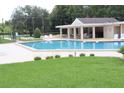 Relaxing community pool with covered patio area at 2025 Sylvester Rd # N109, Lakeland, FL 33803