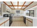 Galley kitchen with wood beams and ample counter space at 222 Okaloosa Dr, Winter Haven, FL 33884