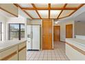 Kitchen with wood-beamed ceiling and white cabinets at 222 Okaloosa Dr, Winter Haven, FL 33884