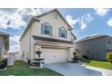 Two-story house with a front yard, driveway, and landscaping at 940 Waterville Dr, Auburndale, FL 33823