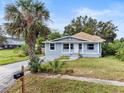 Newly renovated home with gray siding, landscaping, and palm tree at 1800 4Th Nw St, Winter Haven, FL 33881