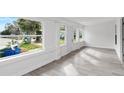 Sunroom featuring large windows, wood-look flooring, and exterior views at 1800 4Th Nw St, Winter Haven, FL 33881