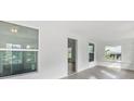 Bright sunroom with large windows and wood-look flooring at 1800 4Th Nw St, Winter Haven, FL 33881