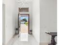 Bright entryway with open door view, showcasing a modern home exterior and paved driveway at 193 Stargrass Dr, Auburndale, FL 33823