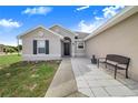 Well-maintained house with a walkway and a bench at 230 Grouper Ct, Poinciana, FL 34759