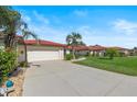 Single-story home with attached garage and landscaped lawn at 2693 Clubhouse Dr, Lake Wales, FL 33898