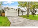 Single-story house with a two-car garage and well-maintained lawn at 316 Montego Se Ct, Winter Haven, FL 33884