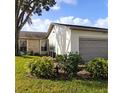 Attractive curb appeal, showcasing a two-car garage and nicely manicured lawn at 4163 Pirates Lndg, Winter Haven, FL 33884