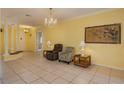 Living room with tile flooring, comfortable seating, and a view to the entryway at 4469 Turnberry Ln, Lake Wales, FL 33859