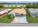 Aerial view of manufactured home with paved driveway and landscaping at 6762 Brentwood Ne Dr, Winter Haven, FL 33881