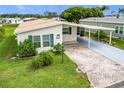 Aerial view of manufactured home with carport and landscaped yard at 6762 Brentwood Ne Dr, Winter Haven, FL 33881