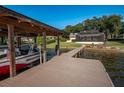 Covered boat dock with room for a boat and jet skis at 1324 Mirror Nw Ter, Winter Haven, FL 33881