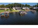 Aerial view of multiple waterfront homes and boat docks at 1324 Mirror Nw Ter, Winter Haven, FL 33881