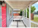 Covered porch with white railings and a bench at 149 Avenue E Sw, Winter Haven, FL 33880