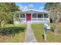 Gray house with red door and covered porch at 149 Avenue E Sw, Winter Haven, FL 33880