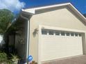 Attached garage with ADT security system at 1561 Vienna Square Dr, Winter Haven, FL 33884