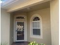 Front door entry with arched window at 1561 Vienna Square Dr, Winter Haven, FL 33884