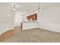 Open dining room with kitchen access and carpet flooring at 1613 Linz Ct, Winter Haven, FL 33884