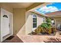 Side entrance with arched windows and brick walkway at 1613 Linz Ct, Winter Haven, FL 33884