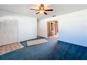 Spacious living room with blue carpet and built-in storage at 221 Dorothy St, Auburndale, FL 33823
