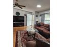 Living room showcasing a comfortable seating arrangement and hardwood flooring at 312 Douglas Park Ave, Davenport, FL 33897