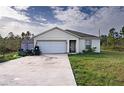 One-story home with attached garage and landscaped yard at 3121 Magnolia Dr, Indian Lake Estates, FL 33855