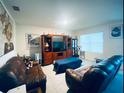 Living room featuring leather sofas and a large entertainment center at 535 Noble Ave, Davenport, FL 33837