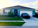 Single-story home with a two-car garage and a modern exterior at 535 Noble Ave, Davenport, FL 33837