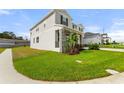 Two-story house with gray siding, stone accents, and a landscaped lawn at 9660 Westside Hills Dr, Davenport, FL 33896