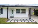 Front entrance with a stone walkway and modern door at 105 Elliott Ln, Winter Haven, FL 33884