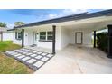 Modern home exterior with covered entryway and walkway at 105 Elliott Ln, Winter Haven, FL 33884