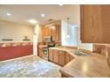 Spacious kitchen with wood cabinets, stainless steel appliances, and tile flooring at 1392 Innsbruck Ct, Winter Haven, FL 33884