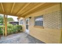 Covered porch with brick walls and a white door at 1807 4Th Nw St, Winter Haven, FL 33881