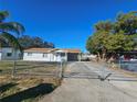 Front view of a charming house with a gated driveway at 2349 Lisa St, Lake Wales, FL 33898