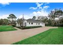 White home with a gray roof, landscaping and driveway at 2997 Sequoyah Dr, Haines City, FL 33844