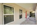 Covered porch with red front door and new windows at 3040 Hutchins St, Eaton Park, FL 33840